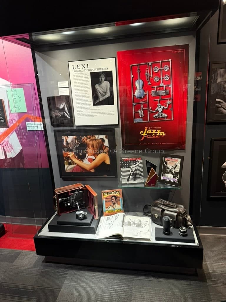 Display case with LENI exhibition materials, camera, and archival objects