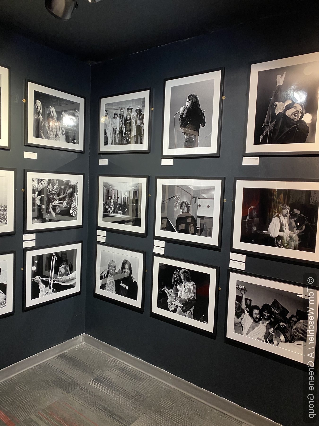 Travelin' Man exhibition gallery wall with framed black-and-white photography selections